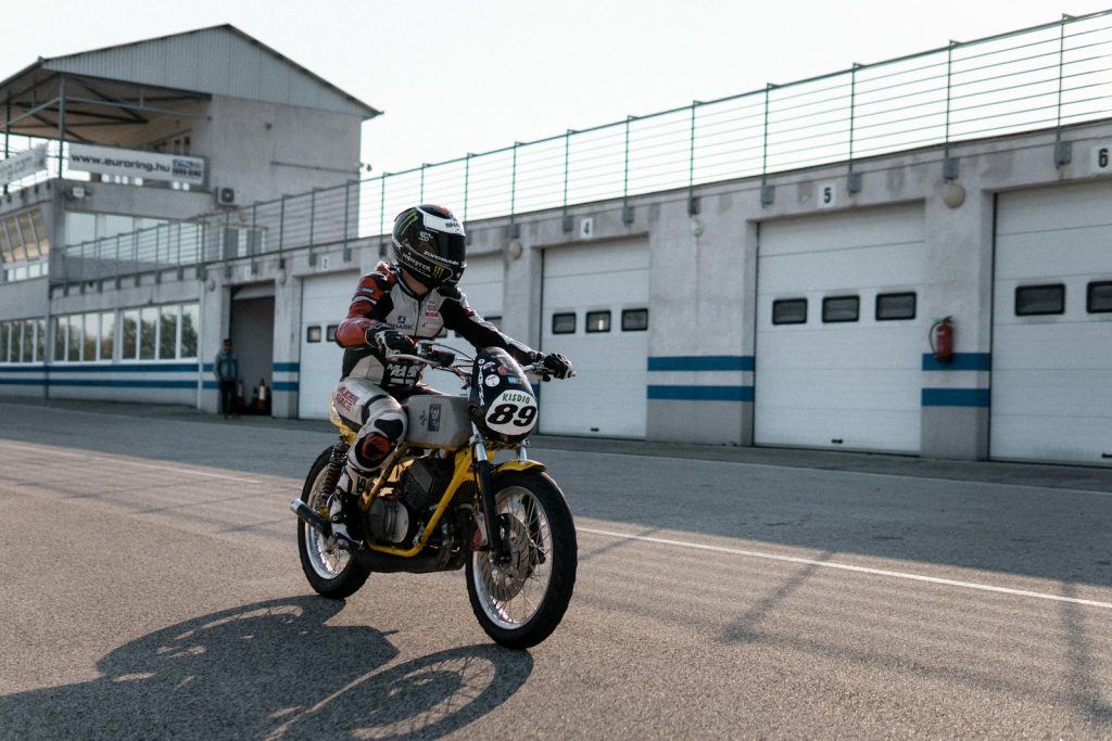 a man riding a motorcycle down a street